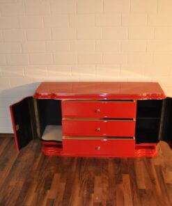Art Deco Lowboard, red highgloss paintjob, wonderful swing doors, 3 drawers with chromehandles, chromeapplications on the foot