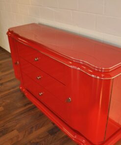 Art Deco Lowboard, red highgloss paintjob, wonderful swing doors, 3 drawers with chromehandles, chromeapplications on the foot